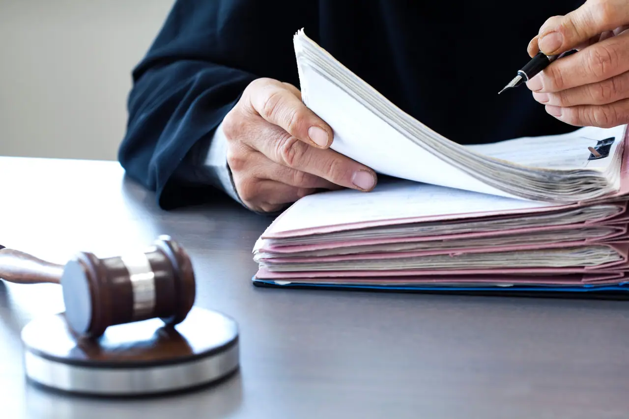 Judge with a gavel on a courtroom desk