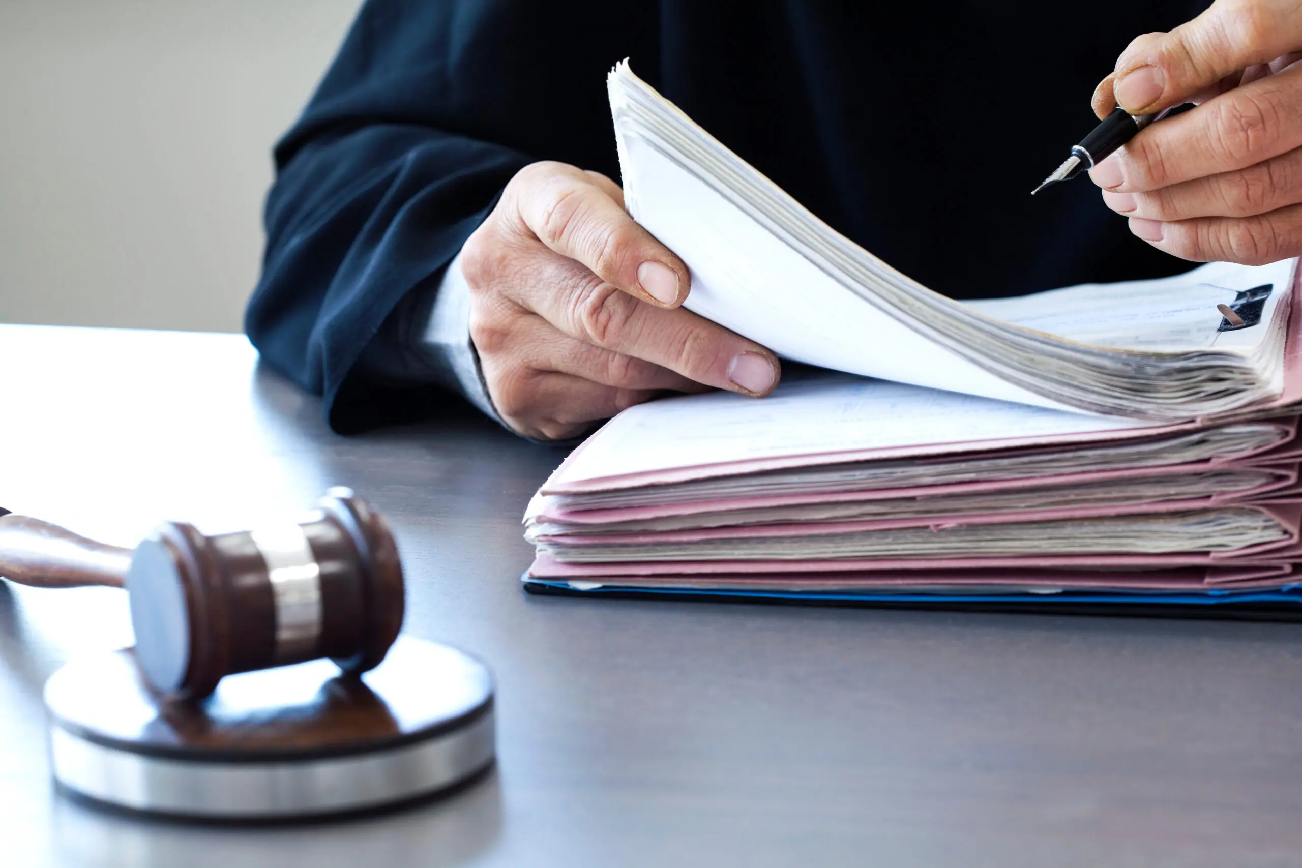 Judge with a gavel on a courtroom desk