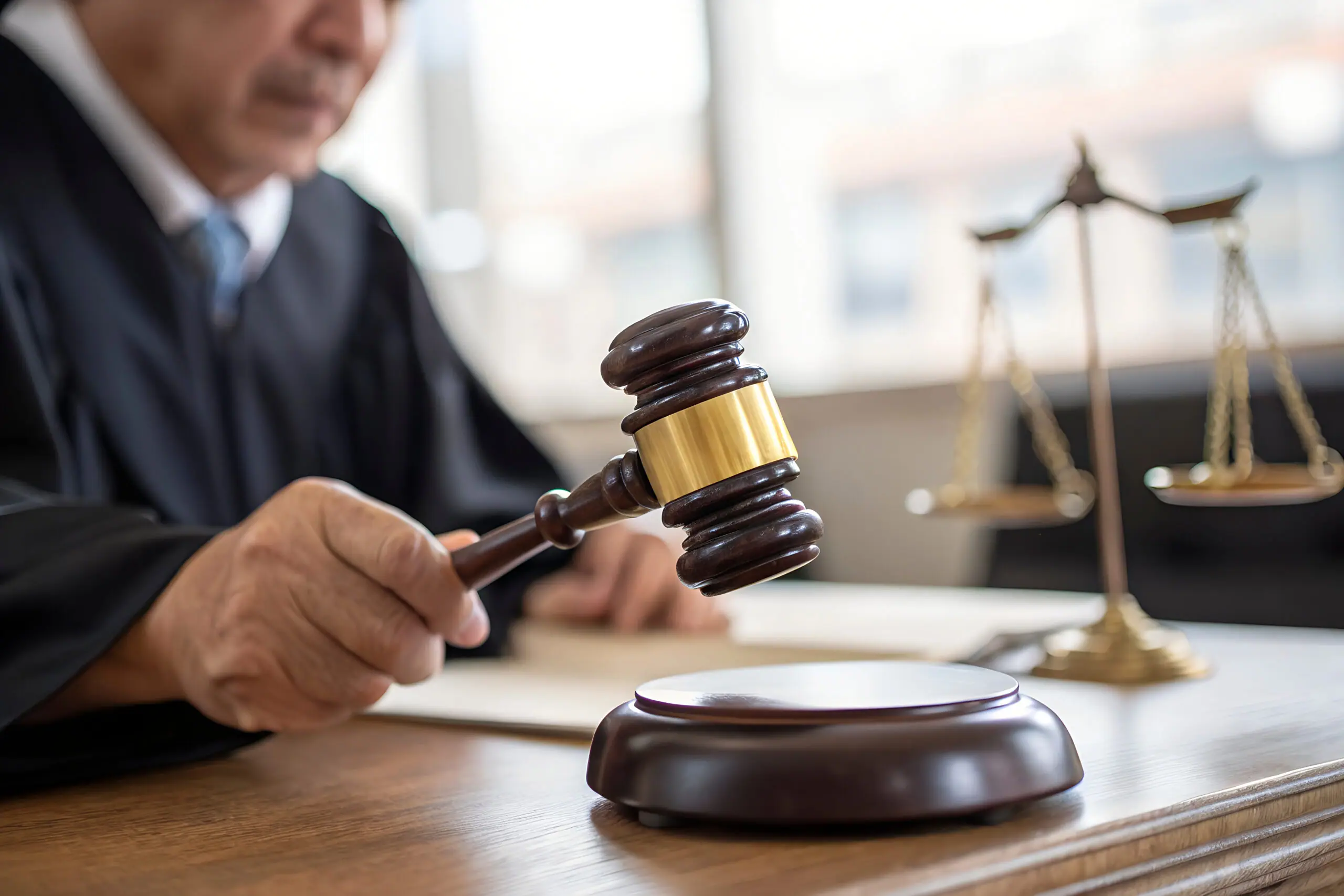 Judge holding a gavel in a courtroom