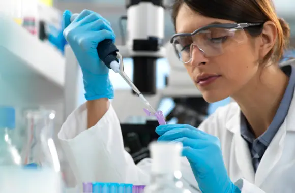 Scientist pipetting a sample in a drug-testing laboratory