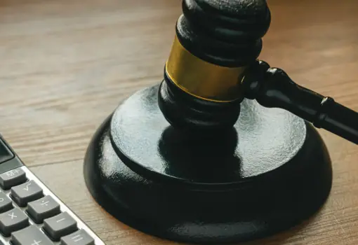 Gavel on a desk beside a calculator