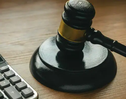 Gavel on a desk beside a calculator