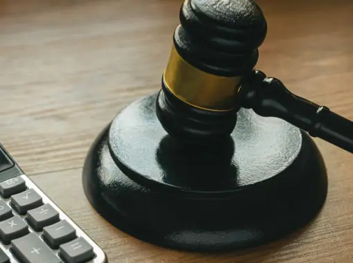 Gavel on a desk beside a calculator