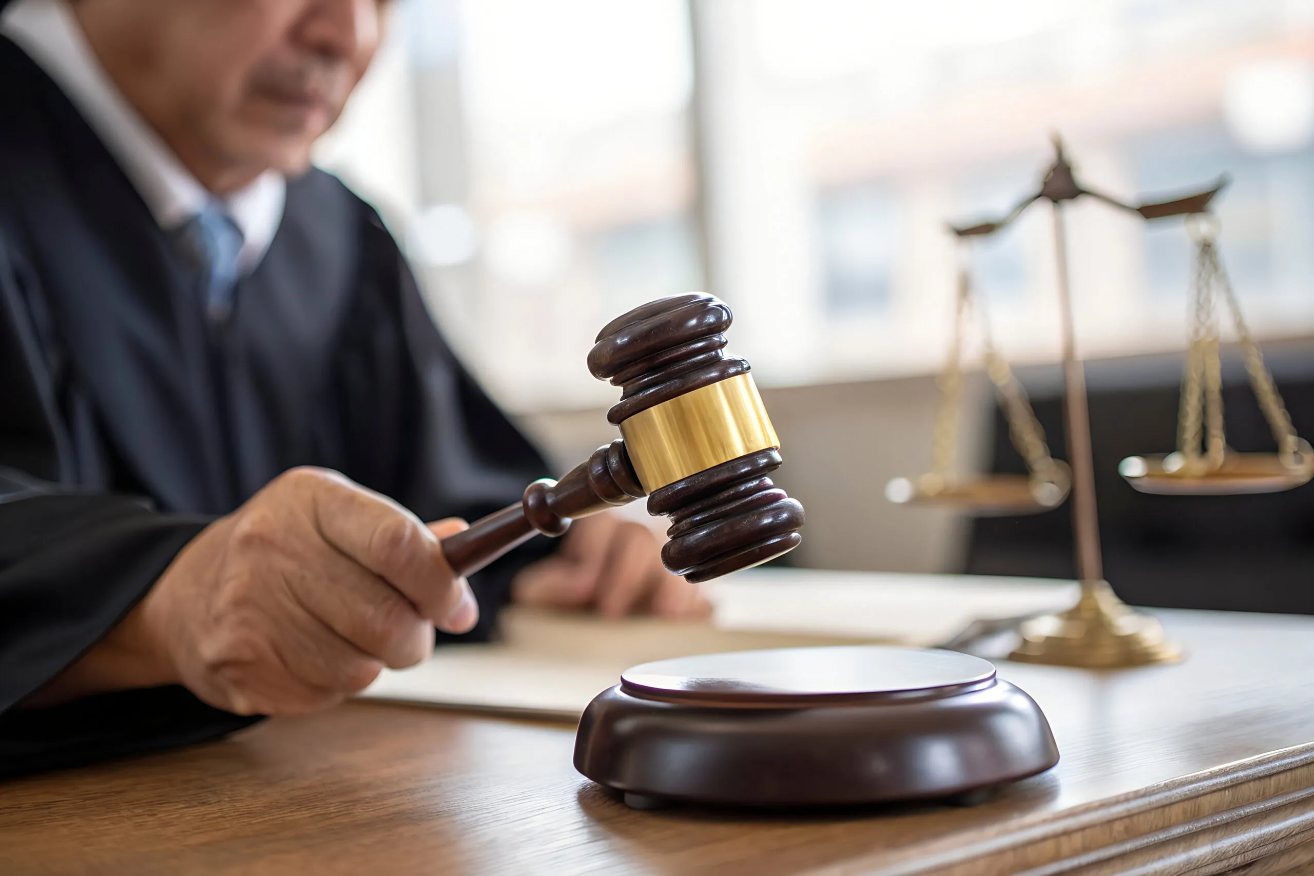 Judge holding a gavel in a courtroom