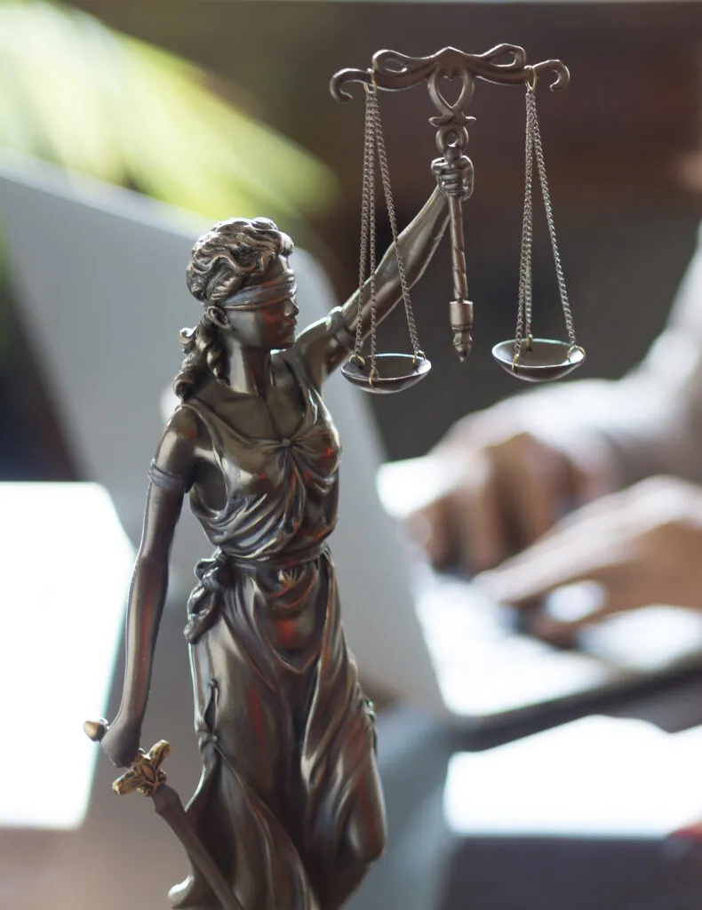 Bronze statue of Justice on a lawyer's desk