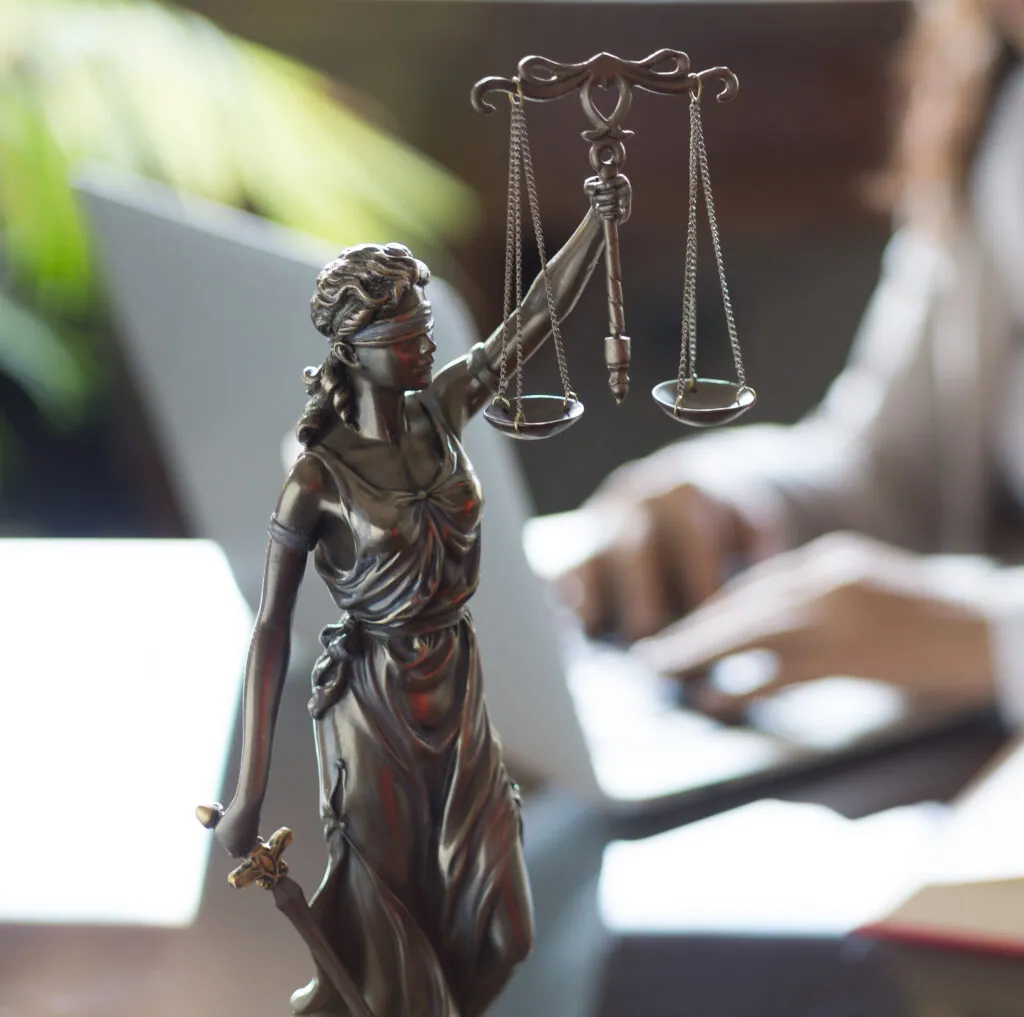 Bronze statue of Justice on a lawyer's desk