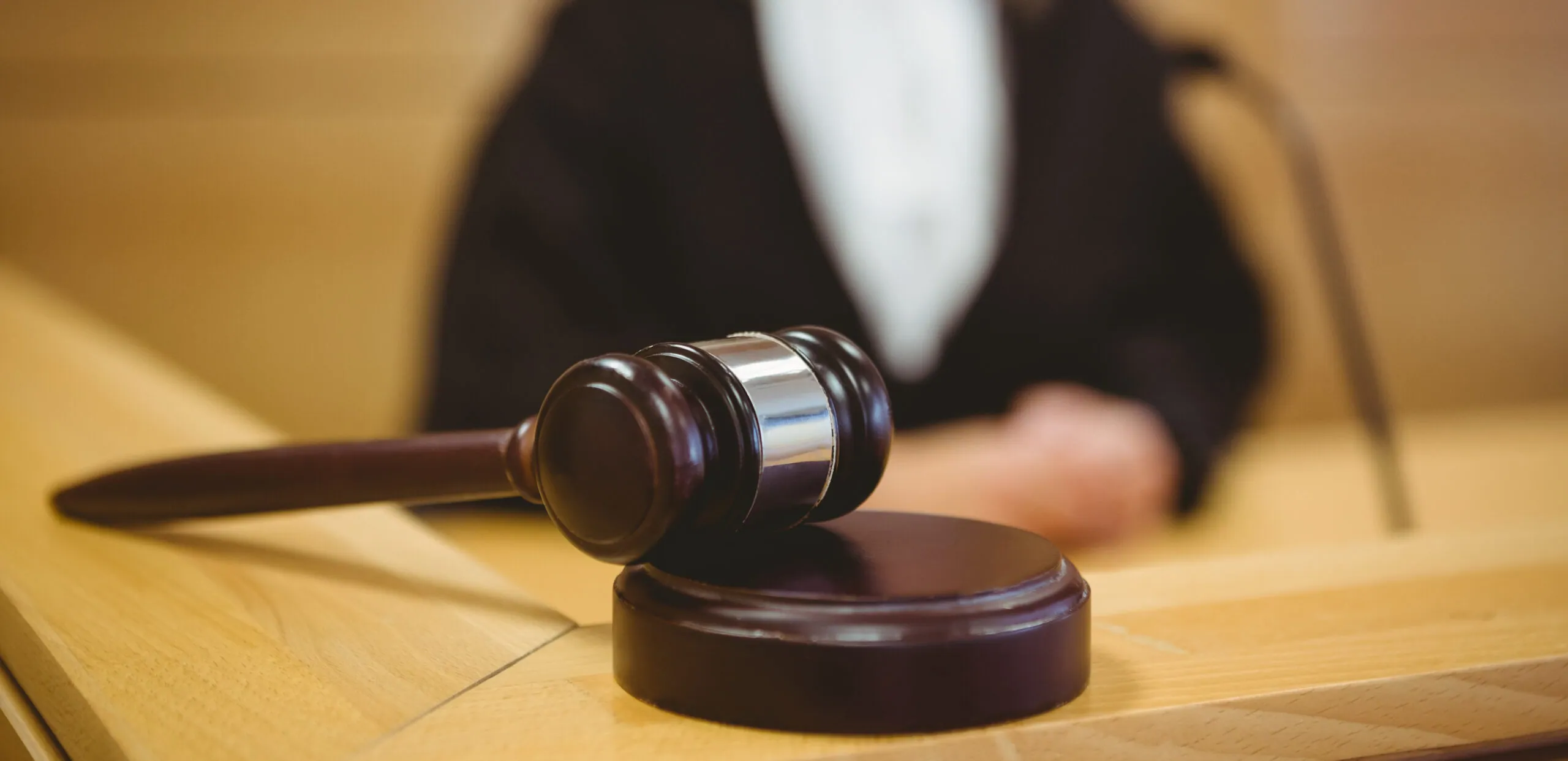 Judge with a gavel on the bench in a courtroom