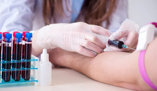 Nurse taking a blood sample for testing
