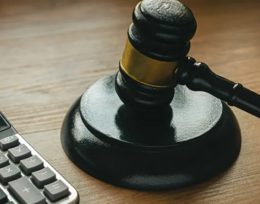 Gavel on a desk beside a calculator
