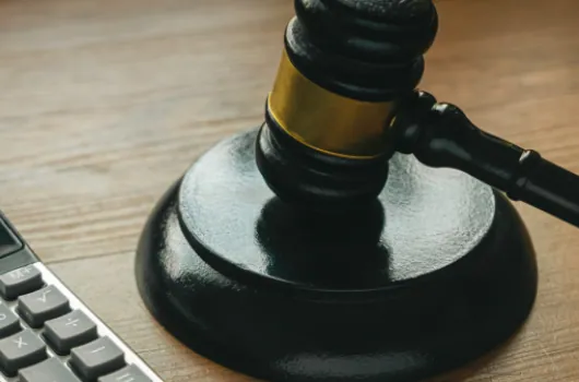 Gavel on a desk beside a calculator