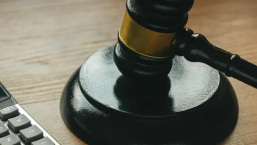 Gavel on a desk beside a calculator