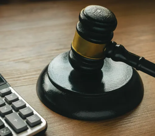 Gavel on a desk beside a calculator