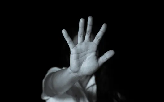 Person holding up a hand to signal stop